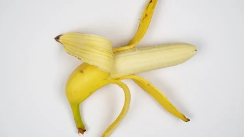 Top View Half Peeled Yellow Banana Rotating On White Background 4K Stock Footage 322143561