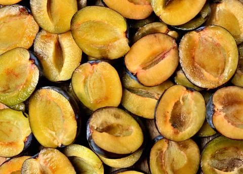 Top view of half pieced fresh garden bio plums texture. Stock Photos