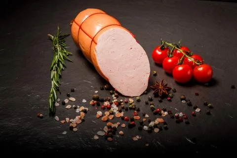 Top view half of sliced boiled sausage with spices and rosemary Stock Photos