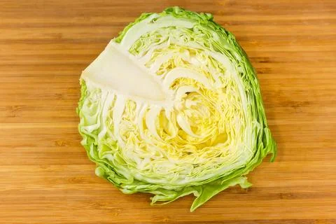 Top view of half of white cabbage on cutting board Фото
