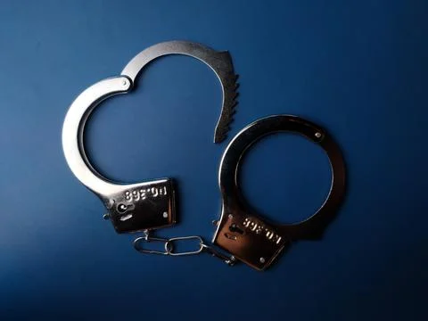 Top view hand cuff on a blue background Stock Photos