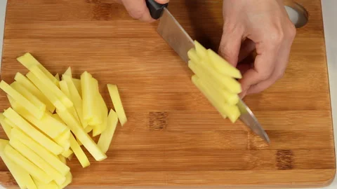 Top View of Hand Cutting Raw Potato into French Fry Sticks Stock Footage 343937886