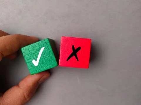 Top view hand holding colored block with symbol right and wrong Stock Photos