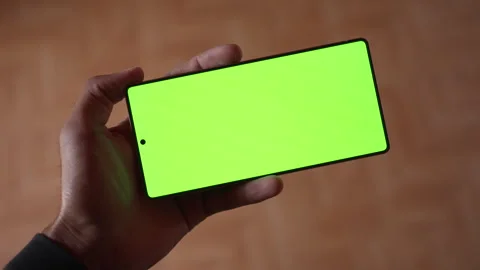 Top View of Hand Holding Smartphone with Green Screen Mockup Chroma Key. Stock Footage 339087393