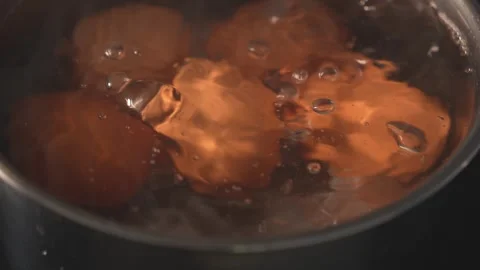 Top view of hand opening pot lid with eggs boiling inside Stock Footage 312767219