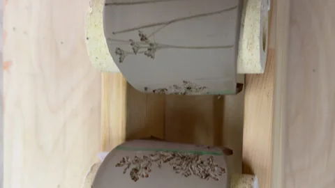 Top view of hand-painted clay napkin rings drying before firing, showcasing bota Video stock 314316993
