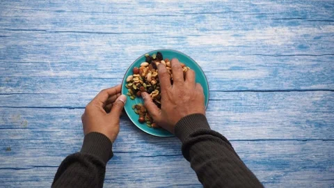 Top view of hand pick mix nuts Stock Footage 337059220