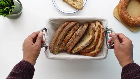 Top view of hand pick wheat multigrain bread from a bucket Video stock 271594674