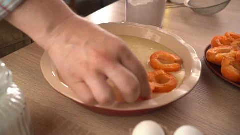 Top view of hand placing fresh apricot on homemade berry pie. Concept of ba.. Stock Footage 338397133