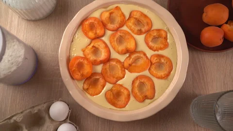 Top view of hand placing fresh apricot on homemade berry pie. Concept of ba.. Stock Footage 338397246
