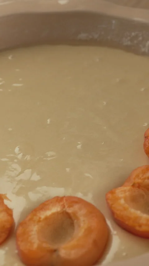 Top view of hand placing fresh apricot on homemade berry pie. Concept of ba.. Stock Footage 338397728