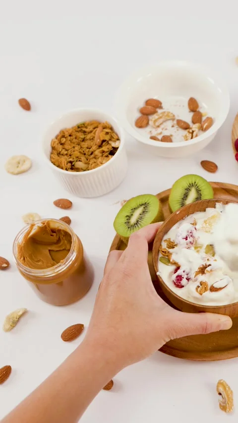 Top View of Hand Preparing Healthy Yogurt Bowl with Fresh Fruit Stock Footage 337519492