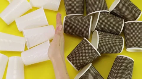 Top view, hand removes plastic glasses and remains Eco glasses Zero waste Stock Footage 143615430