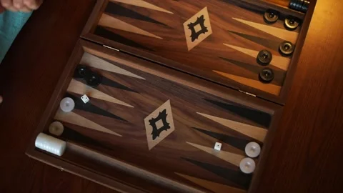 Top View of Hand Rolling Dice on Backgammon Board Stock Footage 332639911