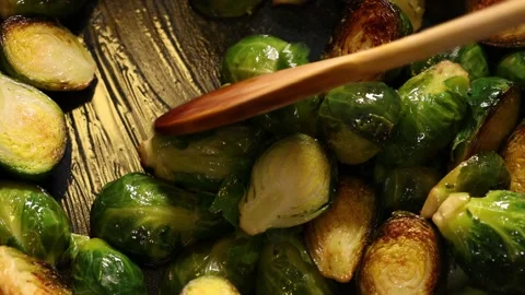 Top view of hand stirring frying brussels sprouts in a pan. Video stock 170894802