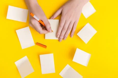 Top view of a hand taking down note in a personal notebook. Stock Photos