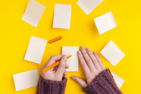 Top view of a hand taking down note in a personal notebook. Stock Photos