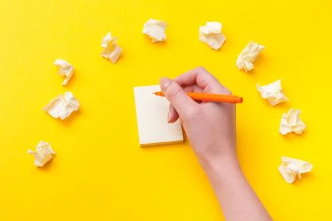 Top view of a hand taking down note in a personal notebook. Stock Photos