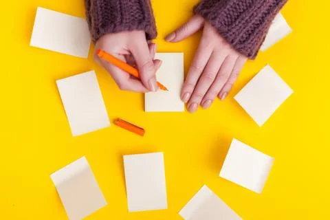 Top view of a hand taking down note in a personal notebook. Stock Photos