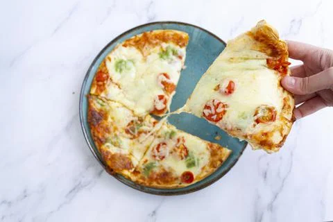 Top view of hand taking a slice of pizza Stock Photos