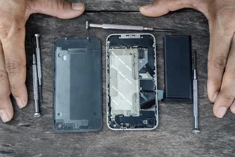 Top view of the hand technician with a screwdriver mobile phone repair insi.. Stock Photos