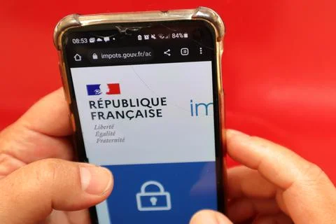 Top view of hand touching smartphone on France government site against red color Foto stock