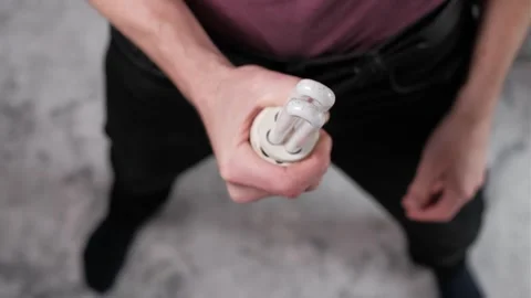 Top View of Hand Twisting Compact Fluorescent Light Bulb Stock Footage 305856012