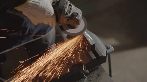 Top view of Hand work wearing gloves while Grinding metal orange flying sparks Stock Footage 137014374