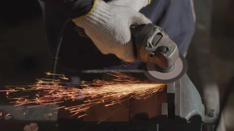 Top view of Hand worker wearing gloves while Grinding metal orange flying sparks Stock Footage 137014898