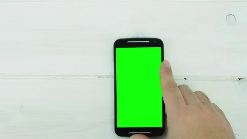 Top view hand working on green screen smartphone on desk Video stock 71933401