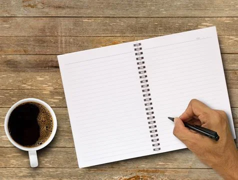 Top view of hand writing on blank notebook Stock Photos