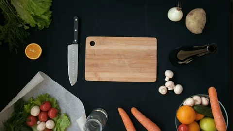 Top view handle shot of young woman cutting fresh vegetables on wooden board Stock Footage 128398286