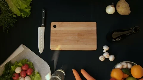 Top view handle shot of young woman cutting fresh vegetables on wooden board Stock Footage 128398659