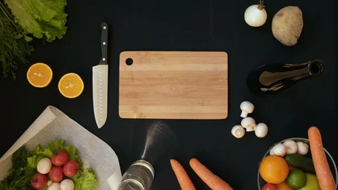 Top view handle shot of young woman cutting fresh vegetables on wooden board Stock Footage 128399050