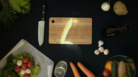 Top view handle shot of young woman cutting fresh vegetables on wooden board Stock Footage 128401721