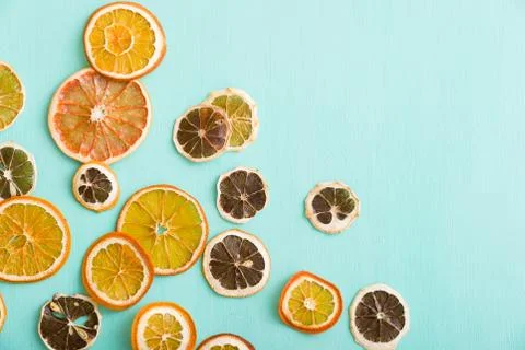 Top view on handmade citrus chips: orange, lemon, grapefruit on turquoise woo Stock Photos