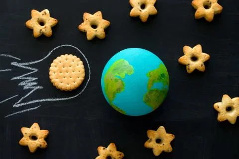 Top view  handmade model  of Earth planet, cookie meteorite   and cookies in  Stock Photos