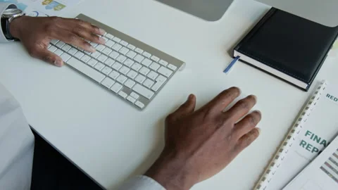 Top View of Hands of Black Manager Working on Report on Computer Stock Footage 302405723