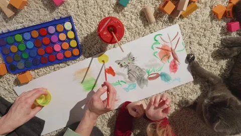 Top view of hands with brushes,process of painting a picture,kid and a pet near Stock Footage 257006508