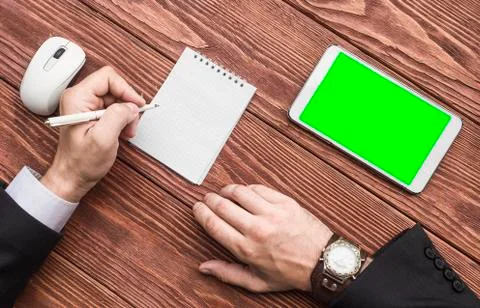 A top view of a hands of a businessman with a tablet PC and notebook on the Foto stock