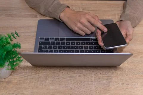 Top view of hands with computer and mobile phone on desk Stock-Fotos
