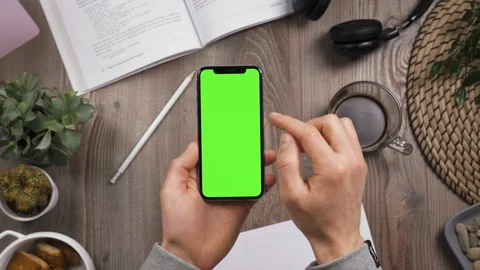 Top view. Hands dials a phone number on the chroma key green screen of the phone Stock Footage 129428973