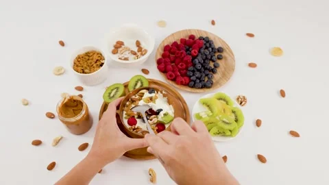 Top View of Hands Eating Healthy Yogurt Bowl with Fresh Fruit Stock Footage 337281285