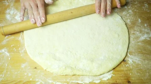 Top view hands in flour rolling out dough Video stock 220683788