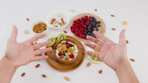 Top View of Hands Gesturing Over Healthy Breakfast Yogurt Bowl Stock Footage 337689811