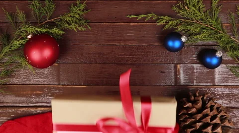 Top view hands gives a gift with the inscription Merry Christmas at wooden desk Stock Footage 68675249