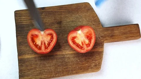 Top view of hands in gloves on board cut with knife tomato horrible. Stock Footage 82736343