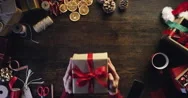 Top View Hands Holding Christmas Presents At Wooden Desk From Above - Red Epic Stock Footage
