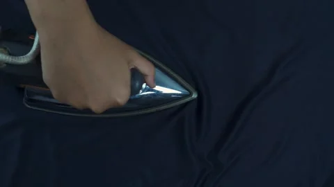 Top view of hands ironing blue cloth 库存影片 276398713