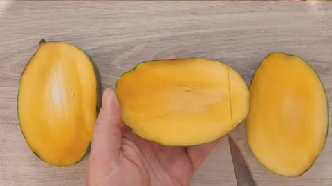Top view of the hands open cut into cubes mango Stock Footage 280599144